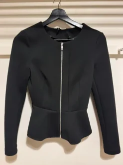 Black blazer with front zipper.