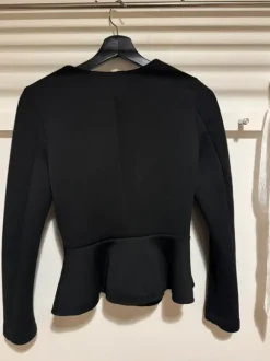 Black blazer with front zipper.