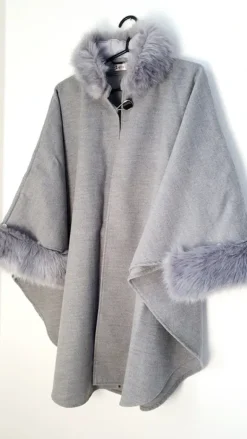 poncho with a faux fur trim on the hood and cuffs.
