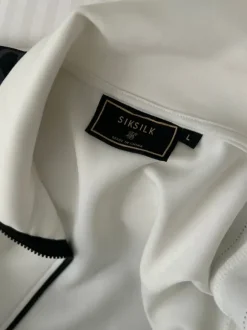 Siksilkin valko/musta verkkatakki.